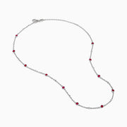 The Ruby Royale 925 Sterling Silver Necklace showcases alternating bezel-set rubies and diamonds along a delicate chain, elegantly displayed against a plain white background.