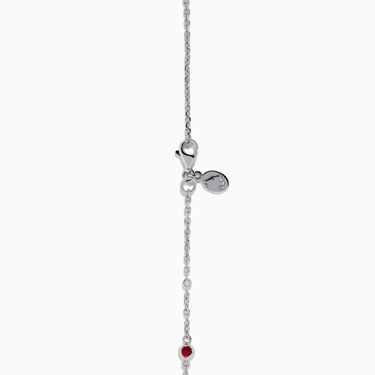The Ruby Royale 925 Sterling Silver Necklace showcases alternating bezel-set rubies and diamonds along a delicate chain, elegantly displayed against a plain white background.