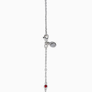 The Ruby Royale 925 Sterling Silver Necklace showcases alternating bezel-set rubies and diamonds along a delicate chain, elegantly displayed against a plain white background.