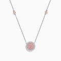 The 14K Two Tone Gold Pink and White Diamond Necklace features a circular pendant with pink stones in the center, clear stones around it, and two small round accents on the gold chain.