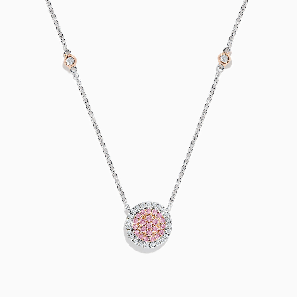 The 14K Two Tone Gold Pink and White Diamond Necklace features a circular pendant with pink stones in the center, clear stones around it, and two small round accents on the gold chain.