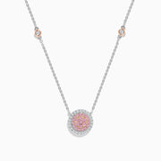 The 14K Two Tone Gold Pink and White Diamond Necklace features a circular pendant with pink stones in the center, clear stones around it, and two small round accents on the gold chain.