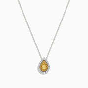 The Canare 14K Two-Tone Gold Pendant showcases a pear-shaped yellow diamond, accented with a halo of white diamonds, hanging from a delicate silver chain.