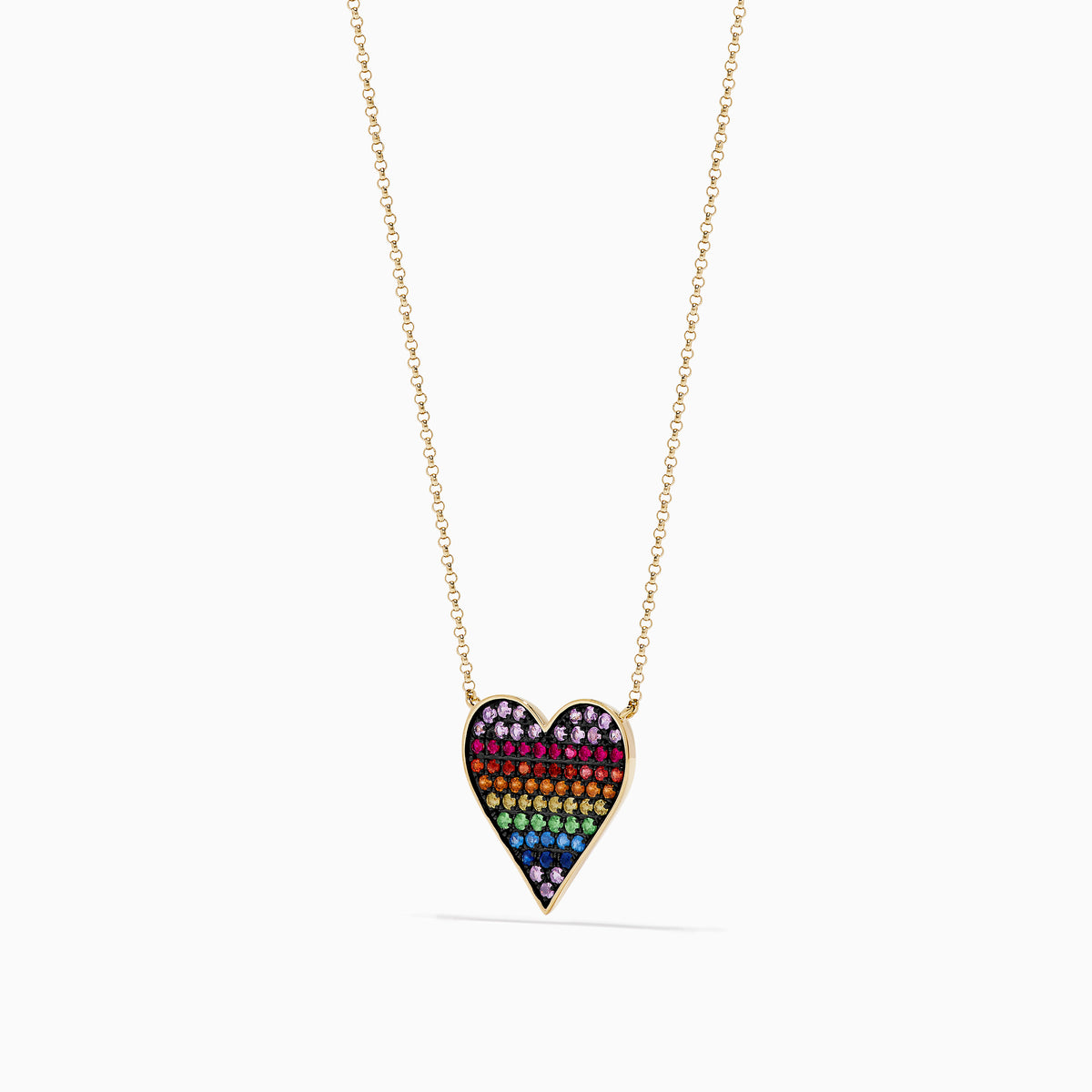 The Watercolors 14K Yellow Gold Multi Color Sapphire Heart Necklace features a gold chain and a heart-shaped pendant adorned with rainbow sapphires arranged from purple to blue.