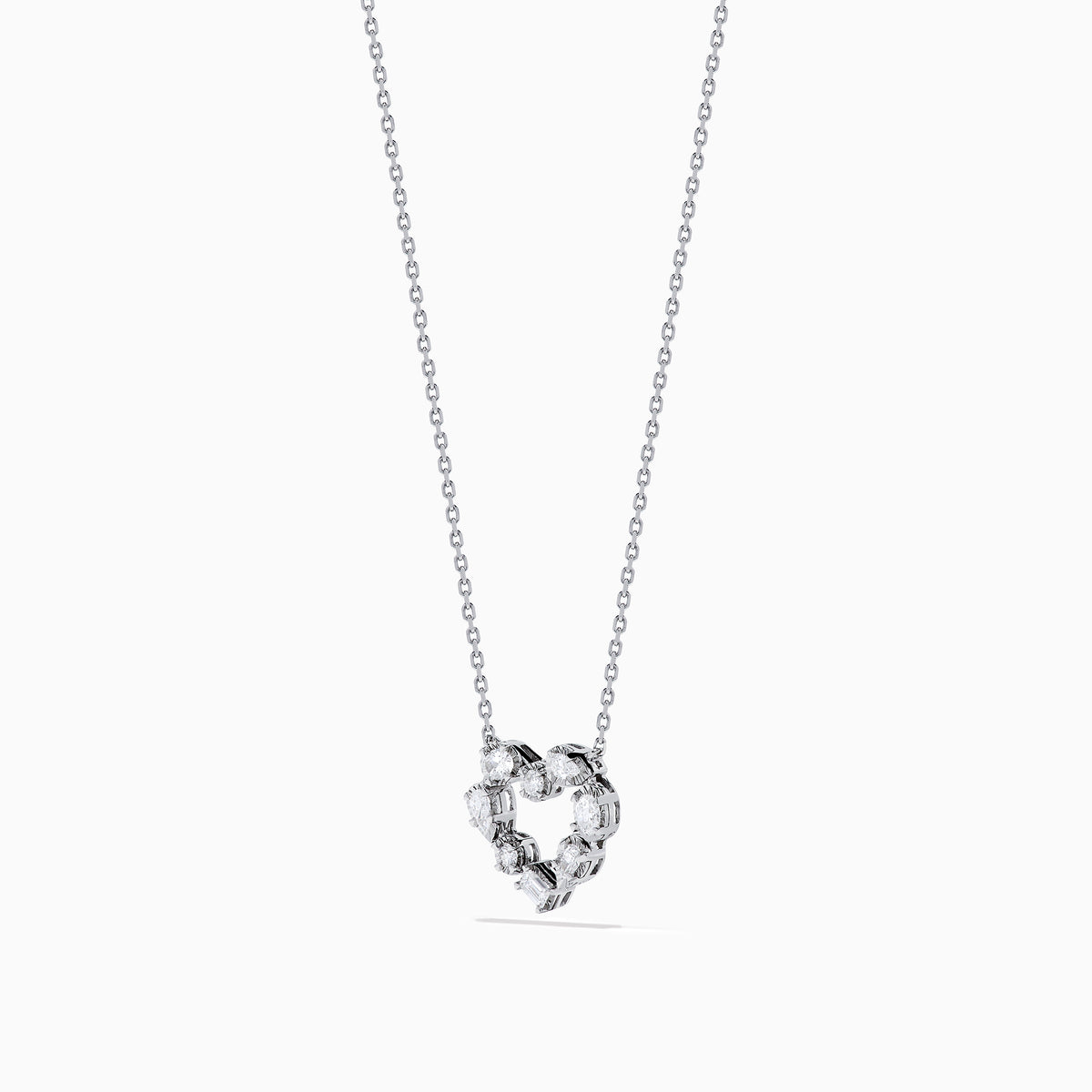 The Novelty 14K White Gold Multi Shape Diamond Heart Necklace features a heart pendant outlined with sparkling diamonds in various shapes, all set in elegant 14K white gold.