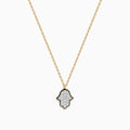 The Novelty 14K Yellow Gold Diamond Hamsa Pendant necklace features a diamond-studded Hamsa outlined in black on a gold chain, adding elegant sparkle to any look. Shown on a plain white background.