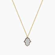 The Novelty 14K Yellow Gold Diamond Hamsa Pendant necklace features a diamond-studded Hamsa outlined in black on a gold chain, adding elegant sparkle to any look. Shown on a plain white background.