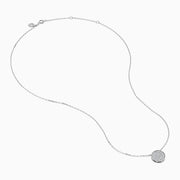 The Pave Classica 14K White Gold Diamond Disc Necklace features a round pendant encrusted with sparkling pave diamonds, elegantly displayed on a delicate white gold chain against a white background.
