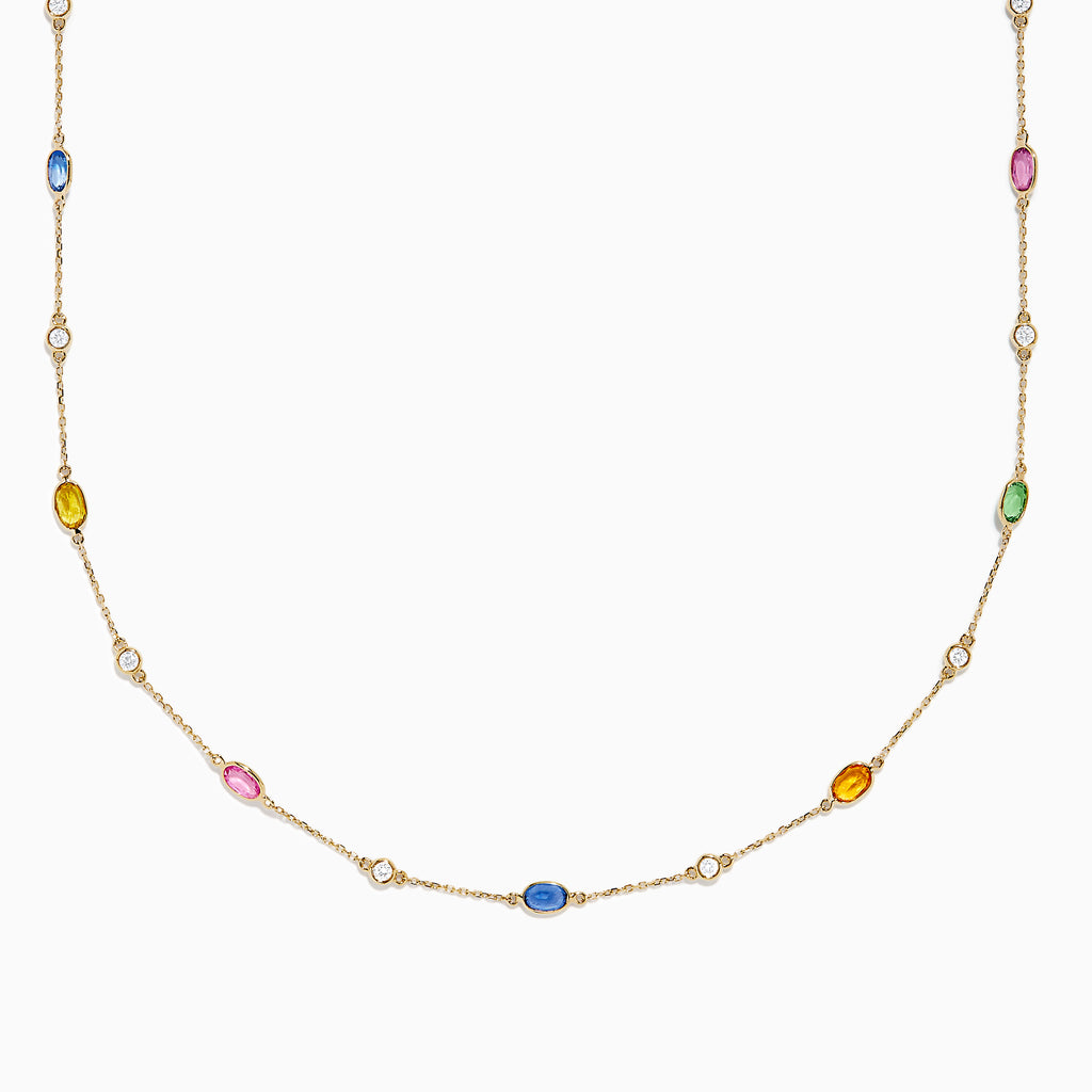 The 14K Yellow Gold Multi Sapphire and Diamond Station Necklace showcases blue, pink, yellow, green, and orange oval sapphires with a diamond station, all delicately spaced along the chain.