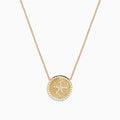 The Seaside 14K Yellow Gold Diamond Starfish Necklace showcases a round, textured pendant with a central starfish design, elegantly outlined and adorned with sparkling diamonds along the edge.