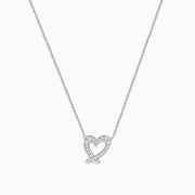 The 14K White Gold Diamond Open Heart Necklace showcases a heart-shaped pendant adorned with diamonds, elegantly suspended from a fine chain against a white background.