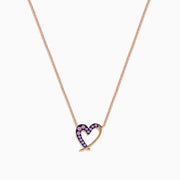 The 14K Rose Gold Pink Sapphire Open Heart Necklace features a delicate heart design, half adorned with sparkling pink sapphires, hanging gracefully from a fine chain for a romantic touch.