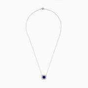 The Nahla Siri 14K Two Tone Gold Tanzanite and Diamond Necklace features a square pendant with deep blue tanzanite, framed by a double halo of sparkling diamonds in silver and gold tones.