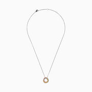 The 18K Tri-Color Gold Natural Yellow, Pink and White Diamond Circle Necklace showcases a round pendant with three rows of diamonds in pink, yellow, and white, displayed on a delicate silver chain against a white background.
