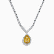 The 18K Two-Tone Gold Yellow and White Diamond Double Halo Necklace features a teardrop-shaped yellow gemstone pendant with a double halo of diamonds, hanging from a white diamond-set chain.