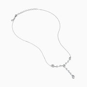 The 14K White Gold Bezel-Set Diamond Lariat Necklace showcases round and teardrop bezel-set diamonds in a Y-shaped design, all gracefully suspended from a delicate chain.