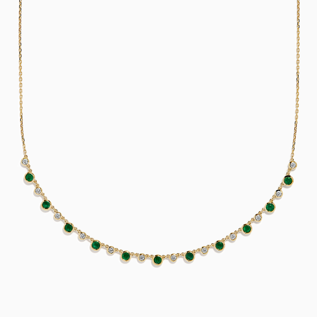 The 14K Yellow Gold Emerald and Diamond Bezel Set Station Necklace features alternating round emeralds and diamonds in bezel settings, evenly spaced along the front curve of the chain, displayed on a white background.