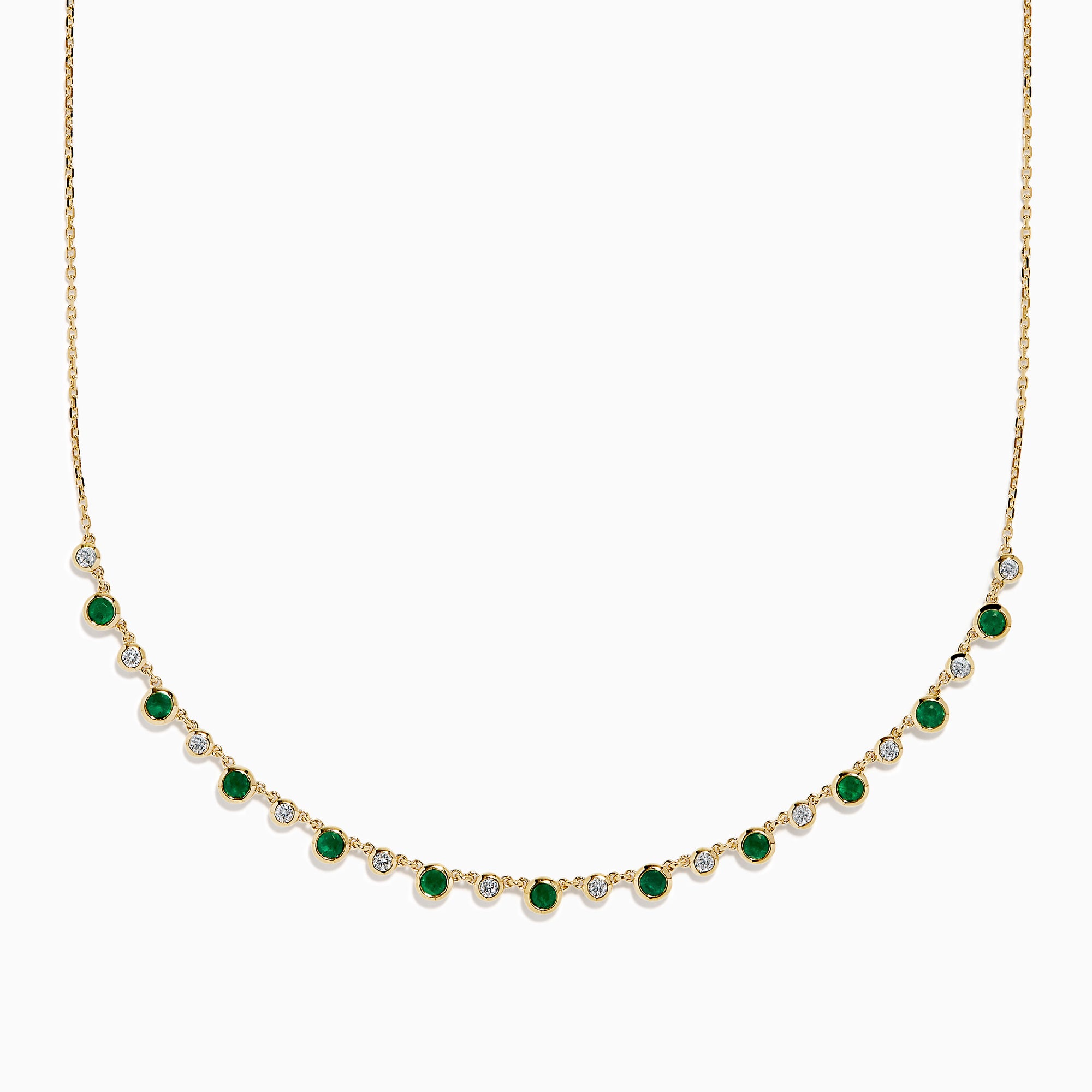 The 14K Yellow Gold Emerald and Diamond Bezel Set Station Necklace features alternating round emeralds and diamonds in bezel settings, evenly spaced along the front curve of the chain, displayed on a white background.