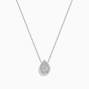 The 14K White Gold Diamond Cluster Pear Shaped Pendant Necklace features a pear-shaped diamond pendant with sparkling accents, set on a delicate white gold chain and shown against a plain white background.
