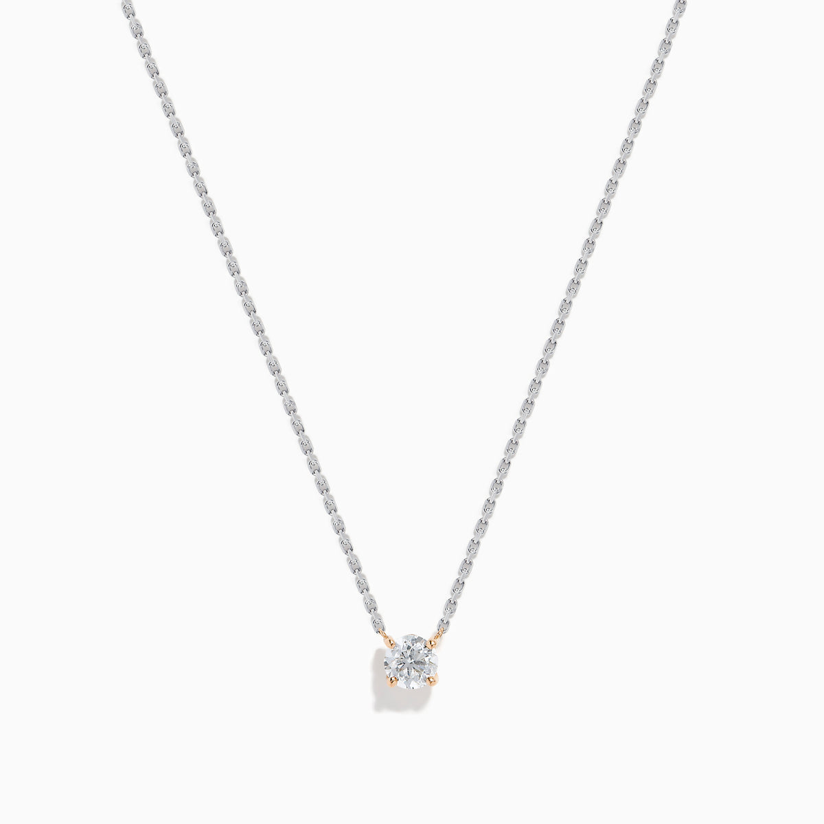 The 14K Two Tone Gold Diamond Solitaire Necklace features a single round-cut diamond in a classic prong setting, elegantly displayed at the center of a fine two-tone gold chain.