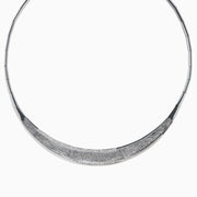 The 925 Sterling Silver Diamond Accented Necklace is a modern, elegant piece with a textured, curved front and sparkling stones on a sleek segmented band.