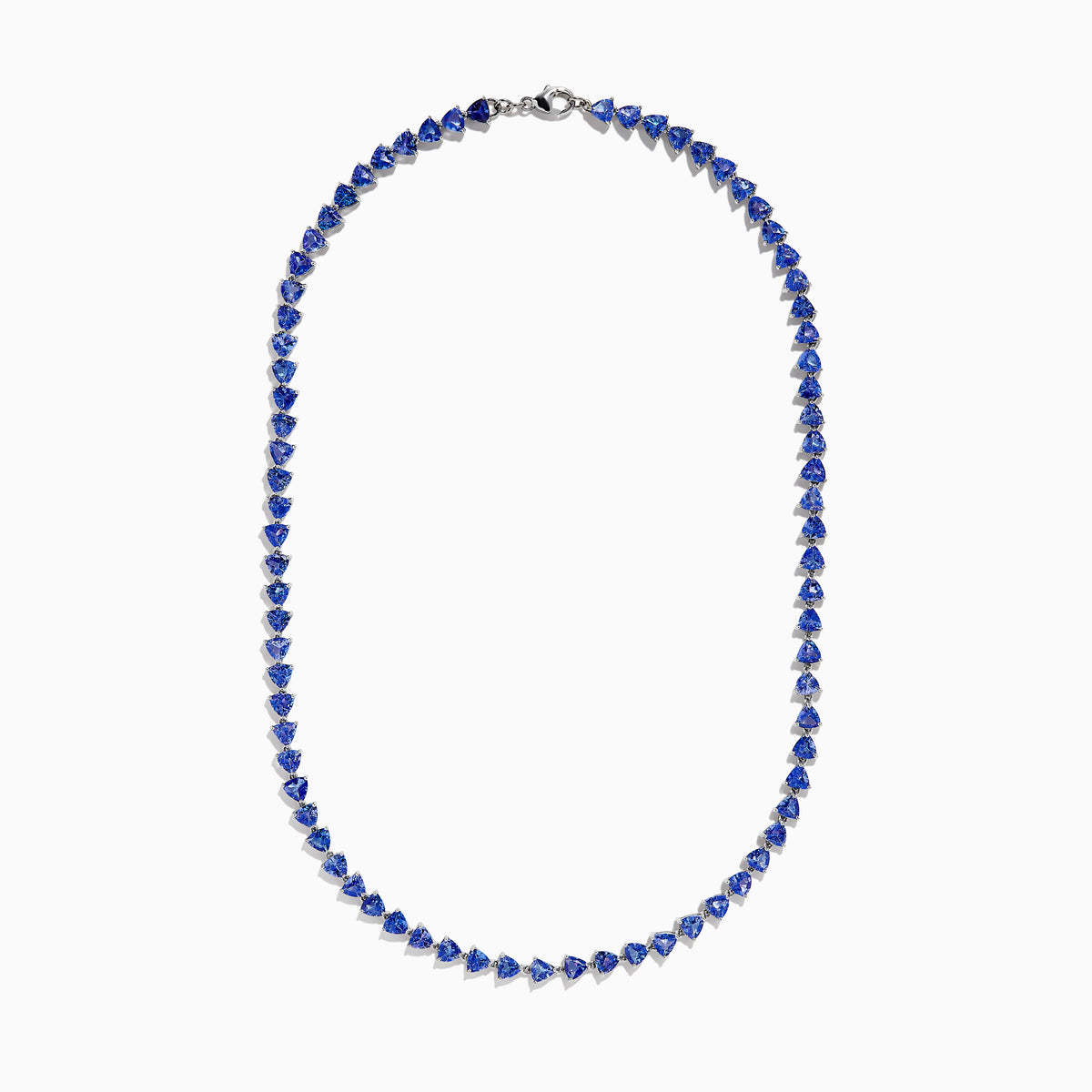 The Nahla Siri Sterling Silver Tanzanite Trillion Cut Tennis Necklace features evenly spaced, triangular tanzanite stones set in 925 silver, creating a continuous, symmetrical design against a plain white background.