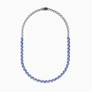 A close-up of the Nahla 14K White Gold Tanzanite and Diamond Necklace, showcasing pear-shaped blue tanzanites and sparkling diamonds set in a symmetrical design against a white background.