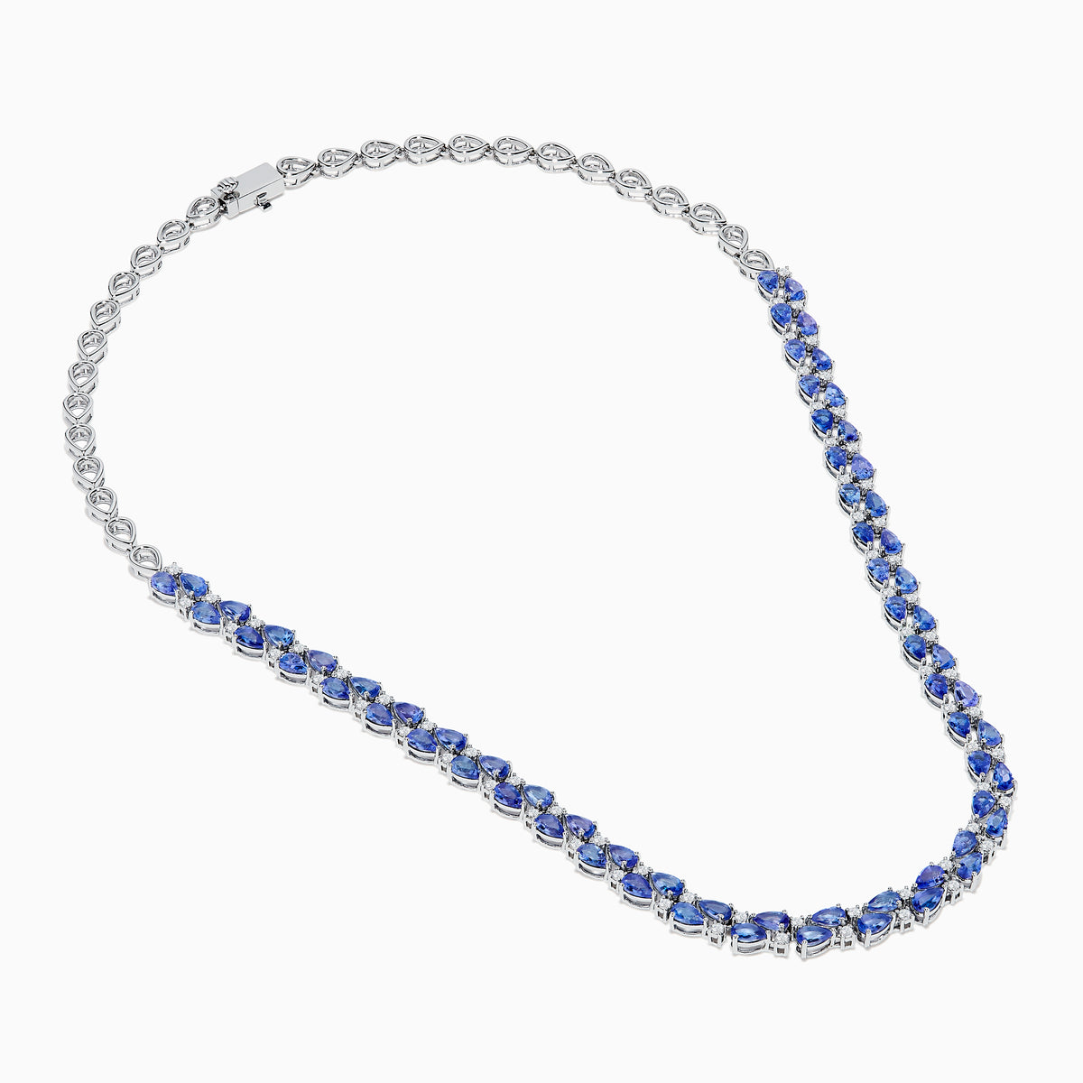 A close-up of the Nahla 14K White Gold Tanzanite and Diamond Necklace, showcasing pear-shaped blue tanzanites and sparkling diamonds set in a symmetrical design against a white background.
