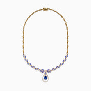The Nahla Siri 14K Yellow Gold Tanzanite and Diamond Necklace features marquise-cut blue tanzanite gemstones and small diamonds, with a teardrop-shaped tanzanite pendant encircled by a sparkling diamond halo.