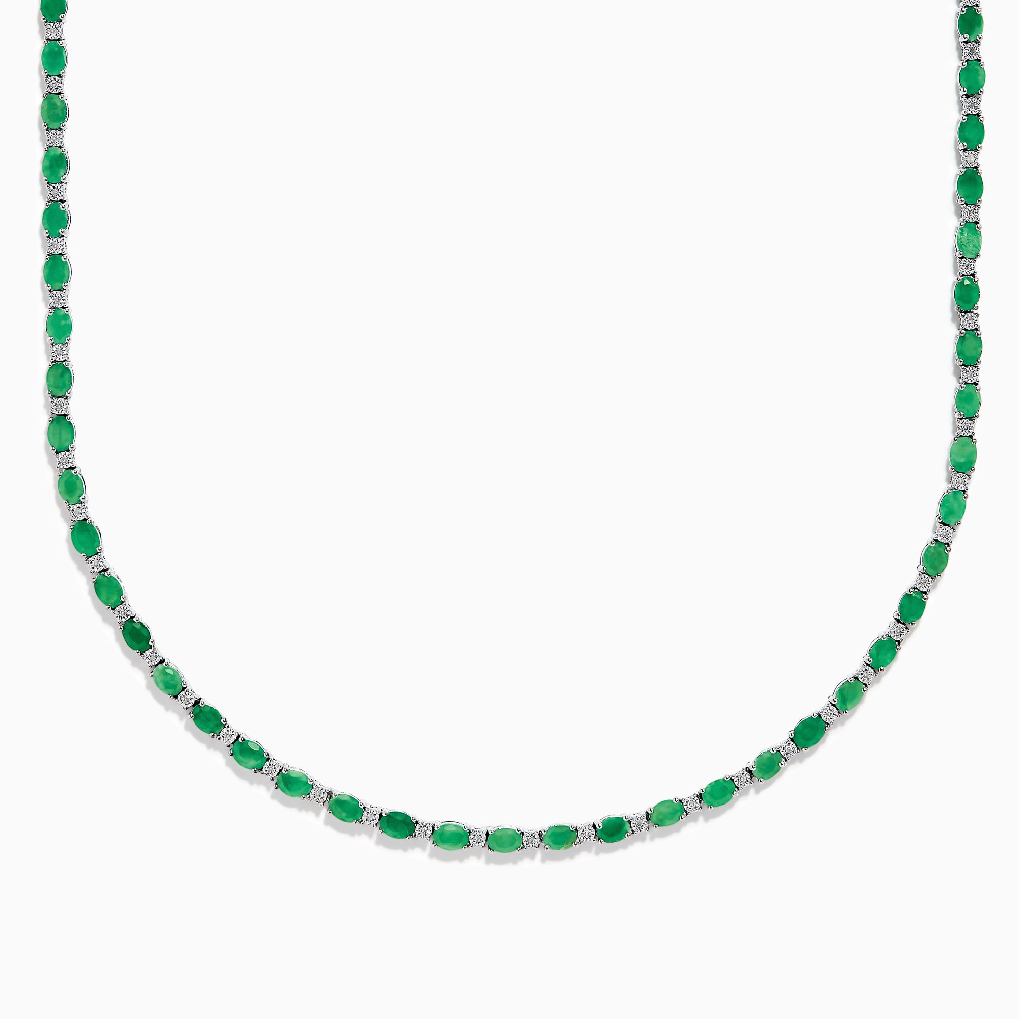 The 925 Sterling Silver Emerald and Diamond Tennis Necklace showcases a sleek row of oval green emeralds and sparkling diamonds set in sterling silver, beautifully arranged against a crisp white background.