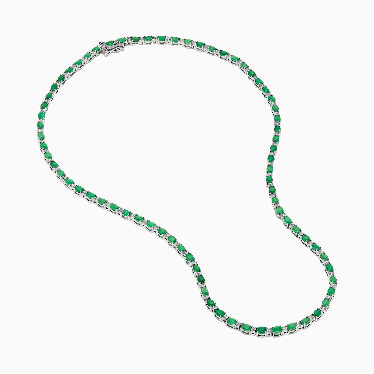 The 925 Sterling Silver Emerald and Diamond Tennis Necklace showcases a sleek row of oval green emeralds and sparkling diamonds set in sterling silver, beautifully arranged against a crisp white background.