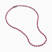 The 925 Sterling Silver Ruby and Diamond Tennis Necklace showcases a continuous row of oval red gemstones in silver prong settings, elegantly displayed against a white background.