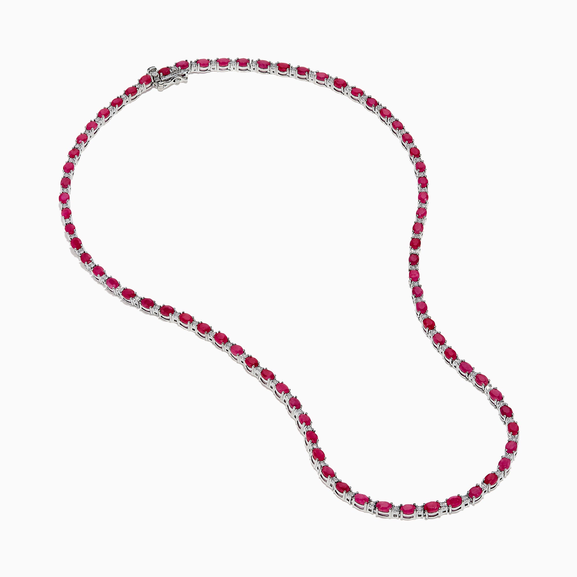 The 925 Sterling Silver Ruby and Diamond Tennis Necklace showcases a continuous row of oval red gemstones in silver prong settings, elegantly displayed against a white background.