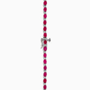 The 925 Sterling Silver Ruby and Diamond Tennis Necklace showcases a continuous row of oval red gemstones in silver prong settings, elegantly displayed against a white background.