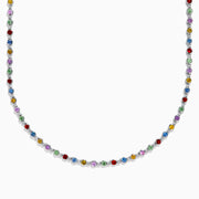 The 925 Sterling Silver Diamond and Multi Sapphire Tennis Necklace features evenly spaced blue, green, red, yellow, and purple gemstones along the chain, creating a vibrant sapphire-inspired design.