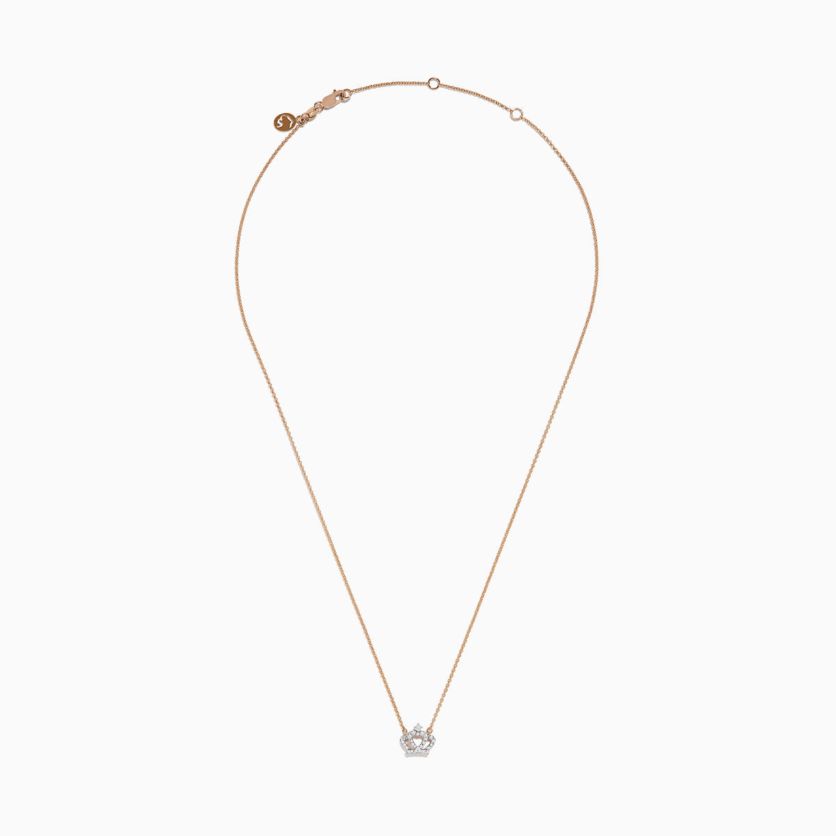 The Novelty 14K Rose Gold Diamond Crown Necklace features a delicate chain and crown-shaped pendant adorned with small sparkling stones, a heart motif at the center, and a single larger stone at the top.