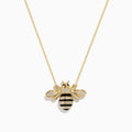 The 14K Yellow Gold Black and White Diamond Bee Necklace features a gold chain with a bee pendant adorned with black and white diamond accents, delicate stripes, and intricate detailing on the head and body. The pendant is symmetrically suspended from the elegant chain in classic Effy style, adding a touch of whimsical elegance.