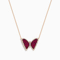 The Ruby Royale 14K Rose Gold Ruby Butterfly Necklace features a butterfly pendant with vivid red and black stones, accented by clear crystals on a delicate rose gold chain.