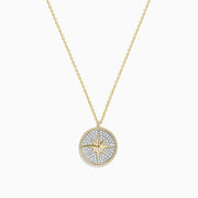 The Novelty 14k Yellow Gold Diamond Compass Pendant features a round star design on a textured silver-tone background, accented with a beaded gold border, and displayed on a plain white background.