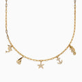The Seaside 14K Yellow Gold Diamond Charm Necklace by Effy features five nautical charms—dolphin, sailboat, starfish, anchor, and seahorse—with some accented by sparkling diamonds for added shimmer.