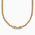 The Signature 14K Yellow Gold Diamond and Emerald Panther Necklace features two jeweled panther head clasps with green gemstone eyes and pavé diamond accents, facing each other at the center.