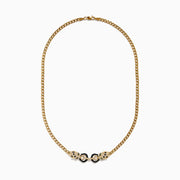 The Signature 14K Gold White and Black Diamond Necklace features dual panther heads with black stones, connected by two black enameled rings for a striking design.