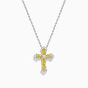 The 14K White Gold Yellow and White Diamond Cross Necklace features a white gold cross pendant with yellow and white diamonds, hanging from a matching chain.