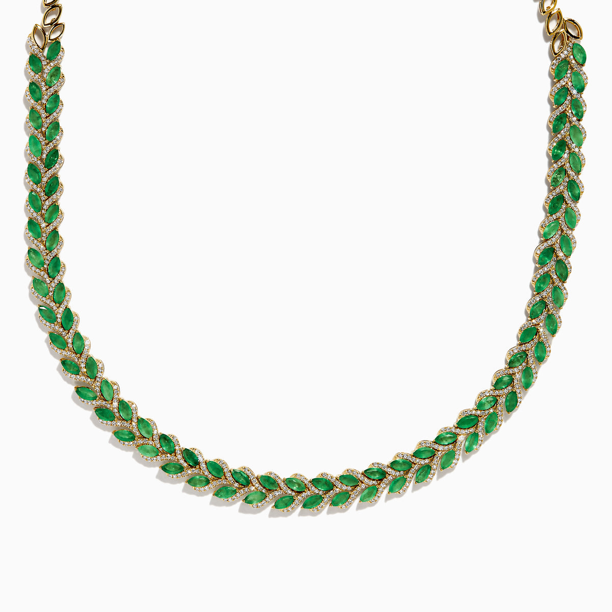 The 14K White Gold Emerald and Diamond Marquise Leaf Necklace features alternating green emeralds and white diamonds in a woven leaf pattern, elegantly displayed against a white background.