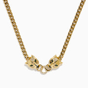The Signature 14K Yellow Gold Diamond and Tsavorite Panther Necklace features two panther heads with tsavorite green eyes and diamond accents, each biting interlocking diamond-encrusted rings at the center.