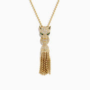 The Web Exclusive 14K Yellow Gold Diamond and Emerald Lariat Tassel Panther Pendant features a diamond-encrusted panther head with emerald eyes, holding a sparkling ring and gold beaded tassels below.