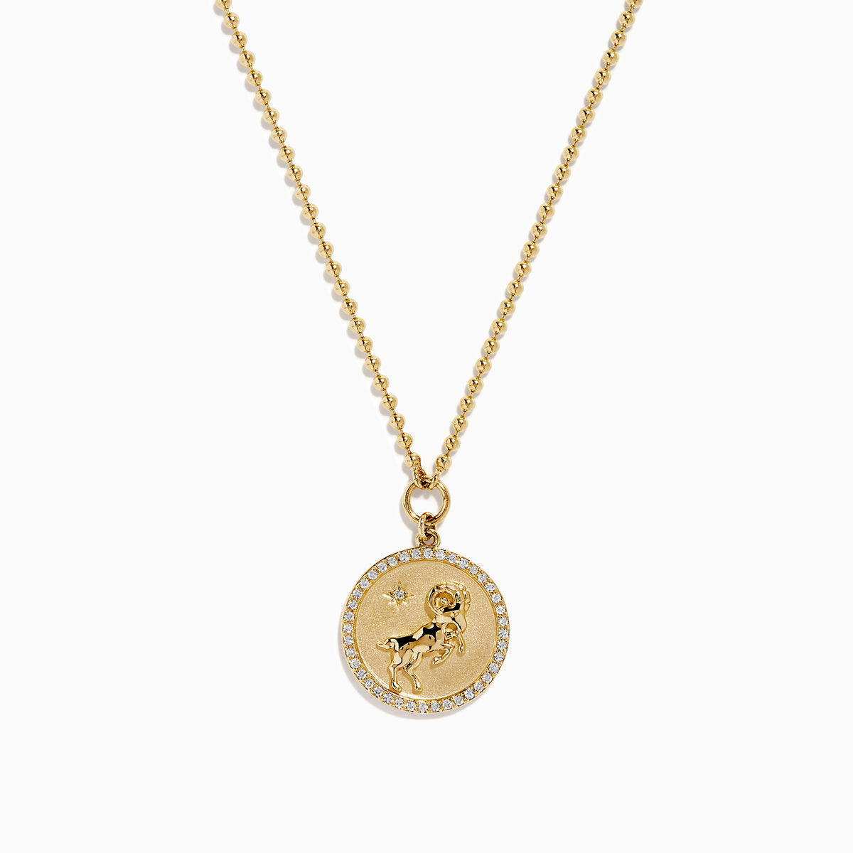The Zodiac 14K Yellow Gold and Diamond Aries Necklace features a round pendant with an embossed ram, accented by sparkling diamonds, hanging from a delicate gold chain against a white background.