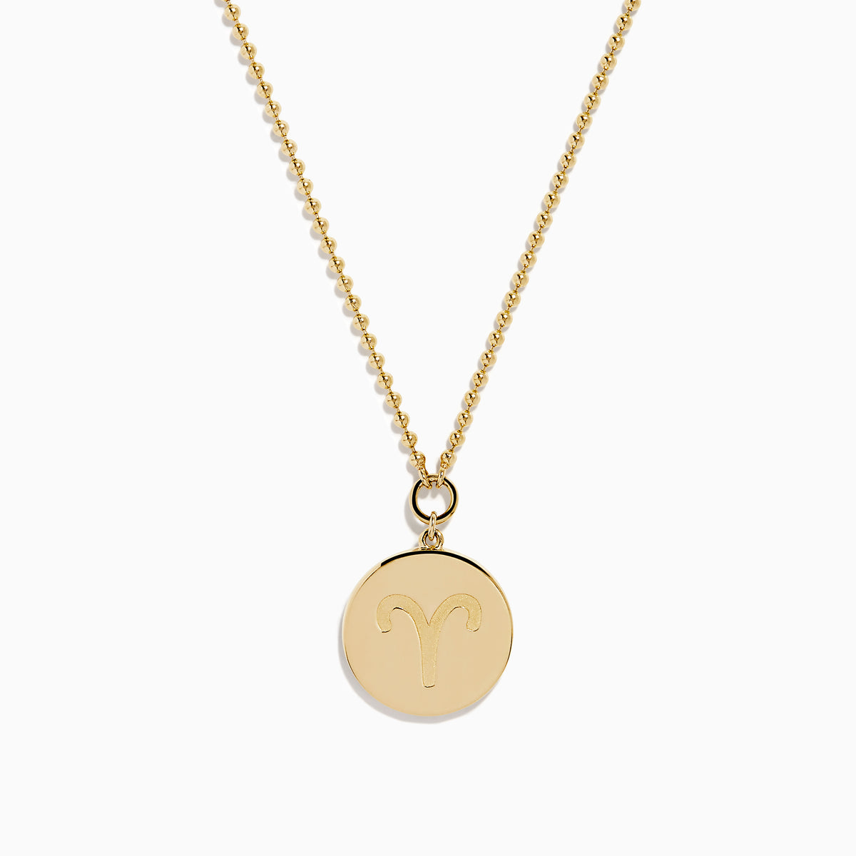The Zodiac 14K Yellow Gold and Diamond Aries Necklace features a round pendant with an embossed ram, accented by sparkling diamonds, hanging from a delicate gold chain against a white background.