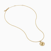 The Zodiac 14K Yellow Gold and Diamond Aries Necklace features a round pendant with an embossed ram, accented by sparkling diamonds, hanging from a delicate gold chain against a white background.