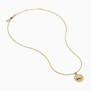The Zodiac 14K Yellow Gold and Diamond Taurus Necklace features a round pendant with an engraved fish design, accented by diamonds, and hangs from a delicate gold chain on a white background.
